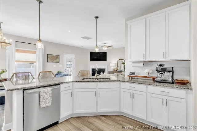 a kitchen with granite countertop a sink and cabinets