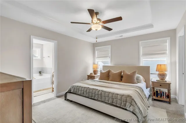 a bedroom with a large bed and a chandelier