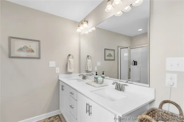 a bathroom with a sink vanity and a mirror