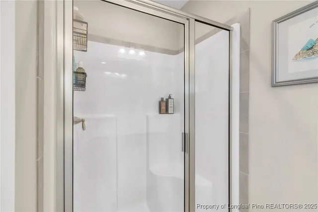 a bathroom with a glass shower door and a bathroom