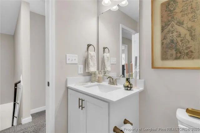 a bathroom with a double vanity sink mirror and toilet