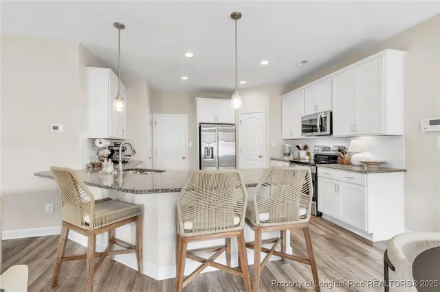 a view of kitchen with microwave and cabinets