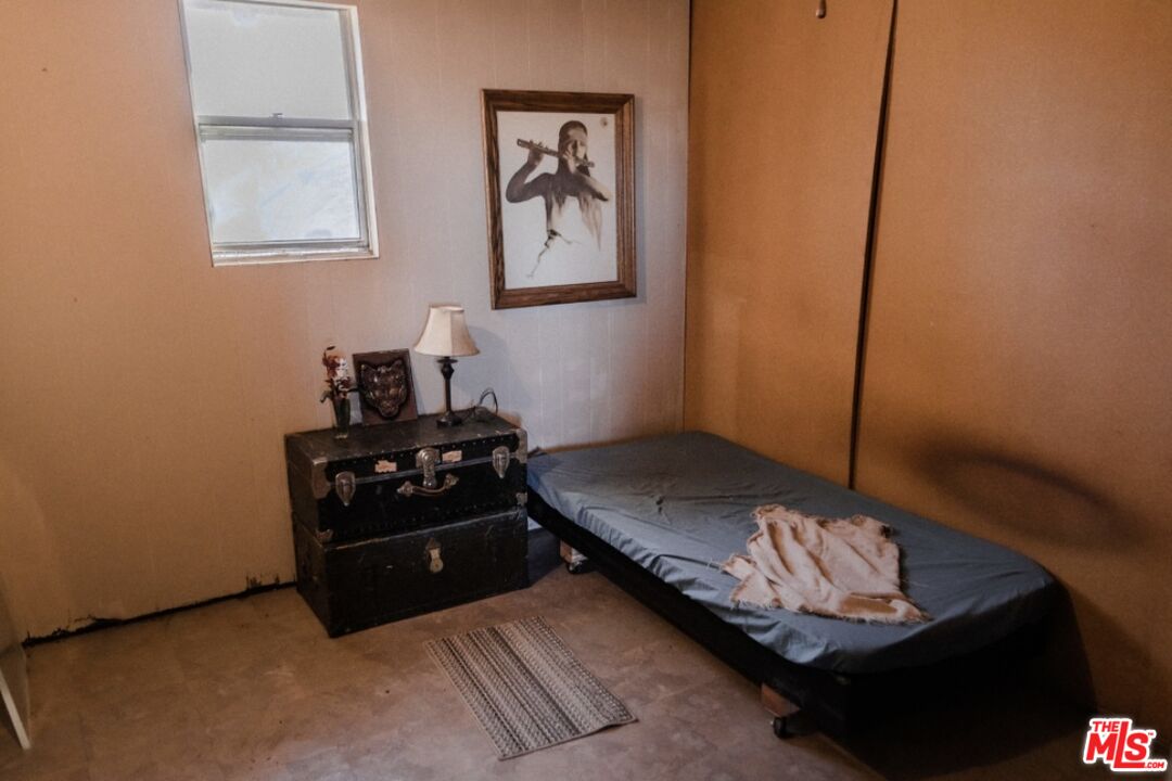 20288 Grey Mountain Road Adelanto, CA 92301 - Photo 6 of 20 a bedroom with a bed and a window