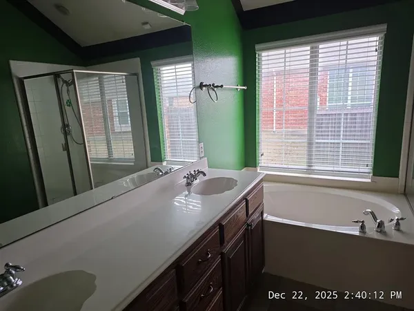 a bathroom with a tub sink and mirror