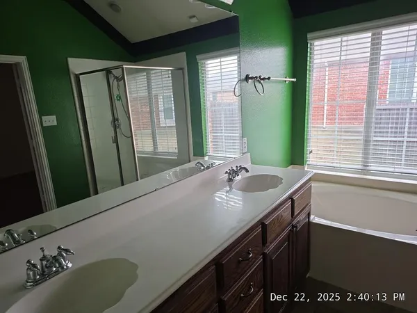 a bathroom with a granite countertop sink and a large mirror
