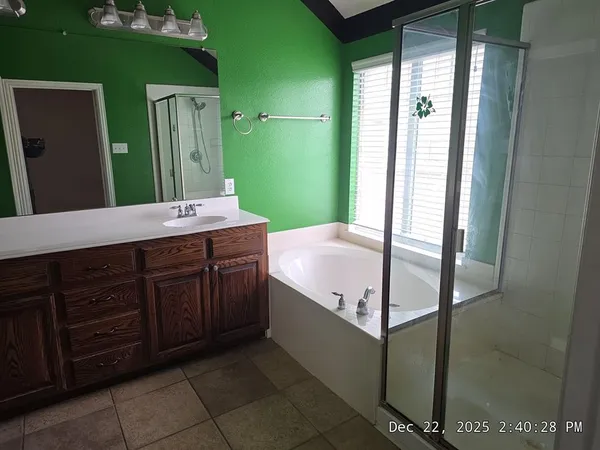 a bathroom with a tub sink and mirror
