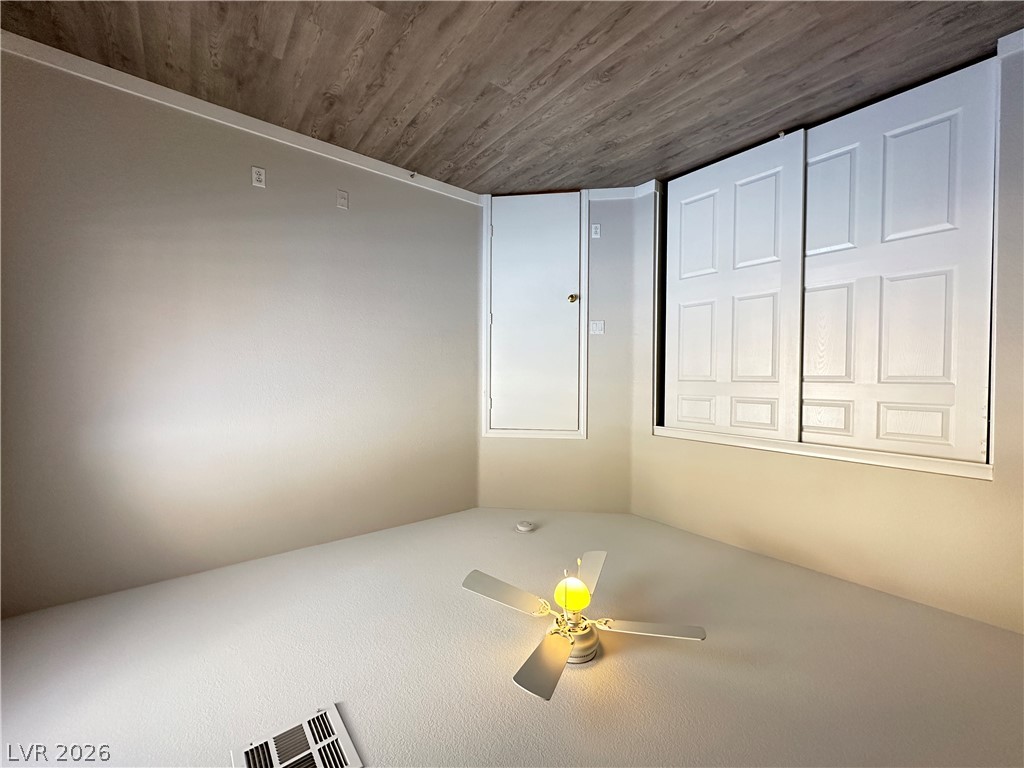 10191 Splendor Ridge Avenue Las Vegas, NV 89135 - Photo 21 of 31 A well-lit bedroom features a stylish ceiling fan and a built-in closet with sliding doors.
