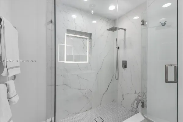 a bathroom with a shower and a glass door