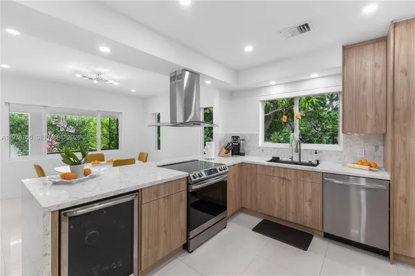 a kitchen that has a sink and a stove in it