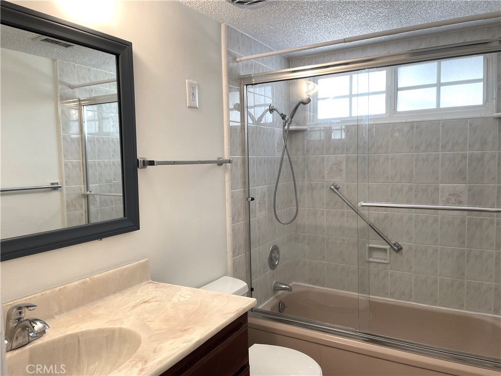3001 Coleridge Drive Rossmoor, CA 90720 - Photo 15 of 25 a bathroom with a granite countertop sink mirror toilet and bathtub