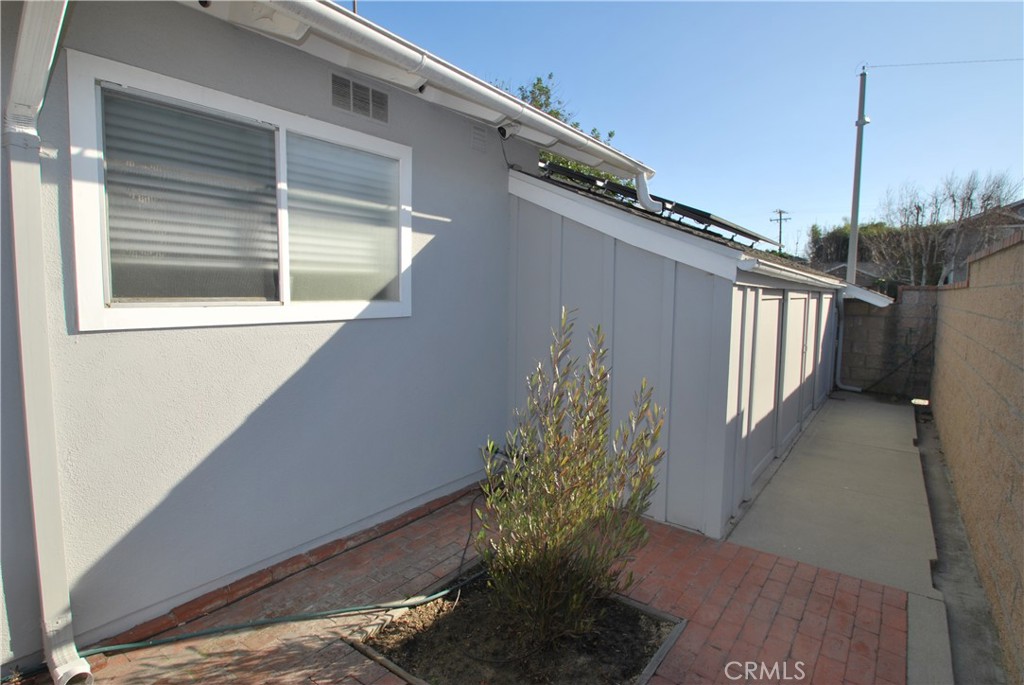 3001 Coleridge Drive Rossmoor, CA 90720 - Photo 20 of 25 a view of a house with a yard and potted plants