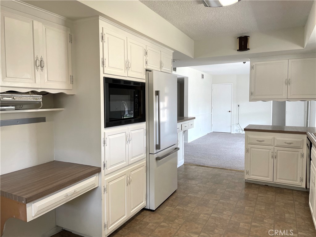 3001 Coleridge Drive Rossmoor, CA 90720 - Photo 7 of 25 a kitchen with stainless steel appliances granite countertop a stove a sink and a refrigerator