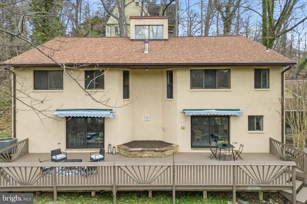 a kitchen with stainless steel appliances a stove a sink a microwave a dining table and chairs