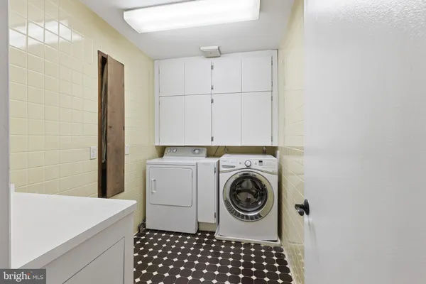 a bathroom with a granite countertop sink mirror vanity and toilet