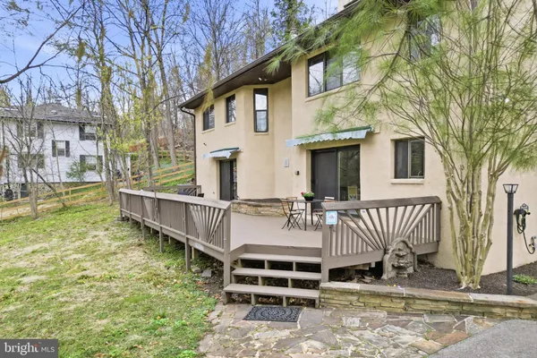 a view of a house with backyard and wooden fence