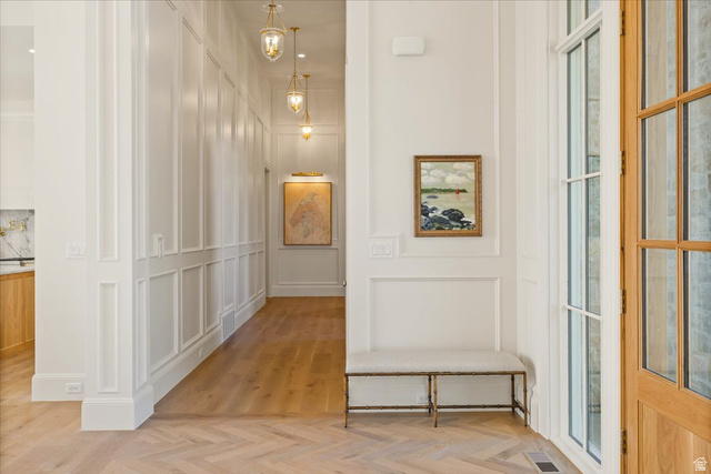 478 South Maple Lakes Drive Mapleton, UT 84664 - Photo 17 of 51 Herringbone wood-finish flooring extending into a hallway with recessed panel wainscoting