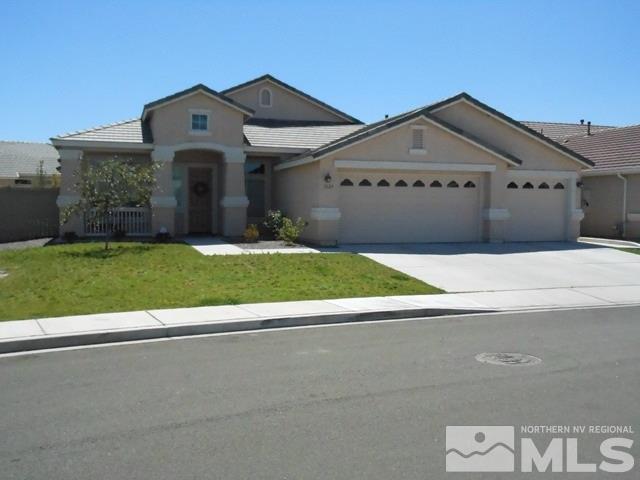 1624 Sewell Drive Reno, NV 89521 - Photo 1 of 14 a front view of a house with a yard and garage