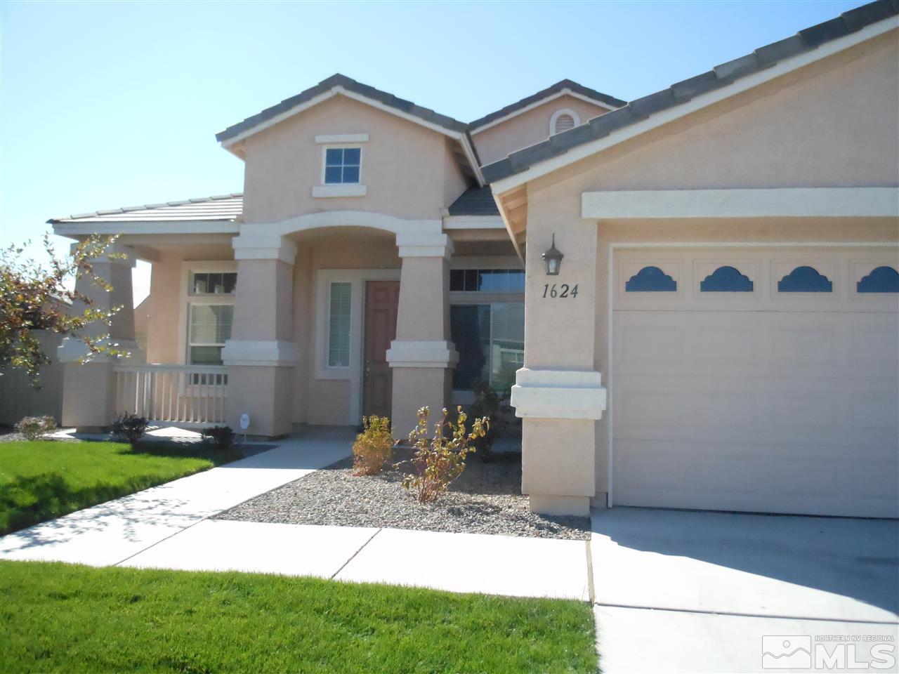 1624 Sewell Drive Reno, NV 89521 - Photo 14 of 14 a front view of a house with a yard and garage