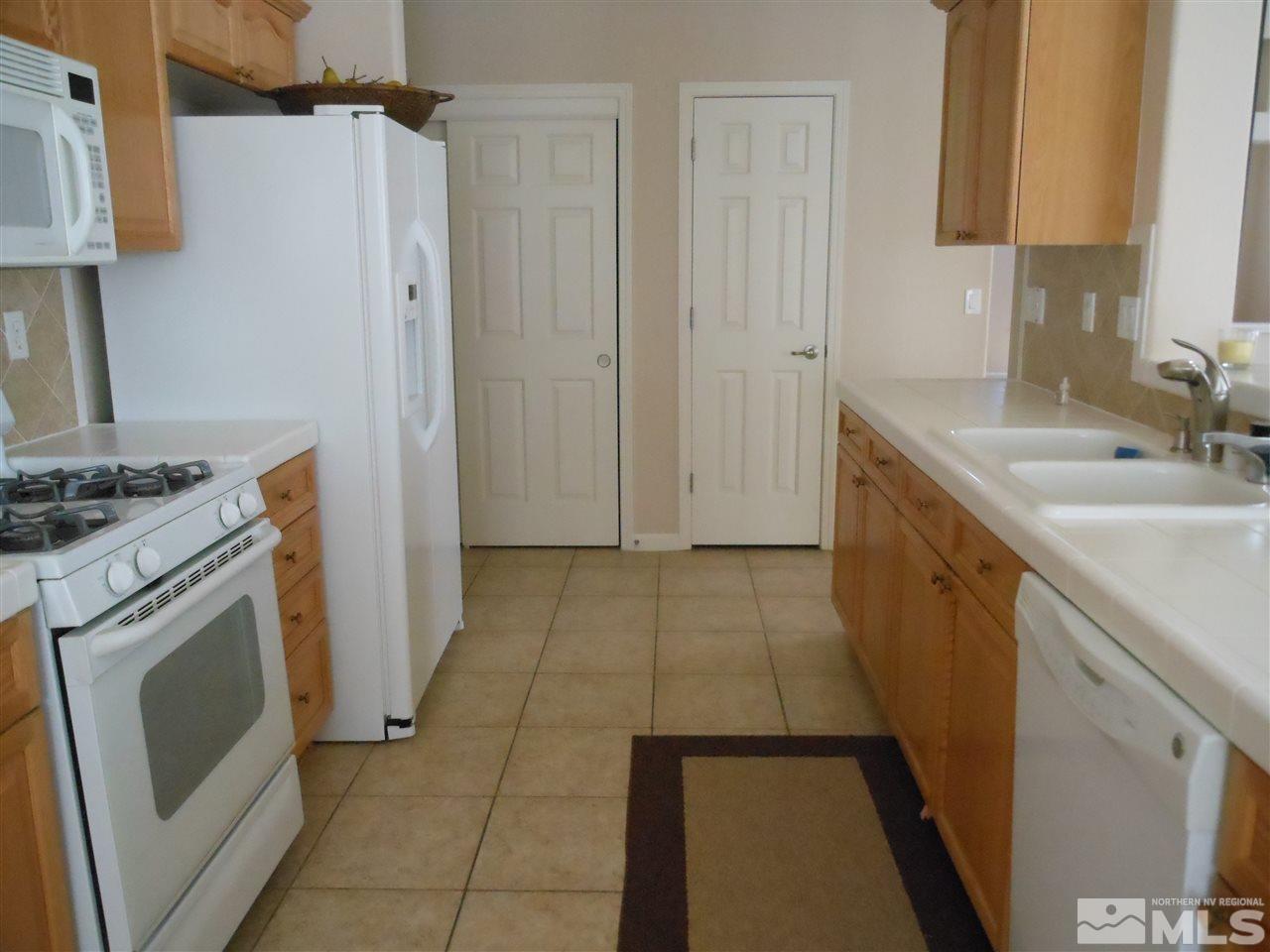 1624 Sewell Drive Reno, NV 89521 - Photo 4 of 14 a kitchen with a sink stove and cabinets