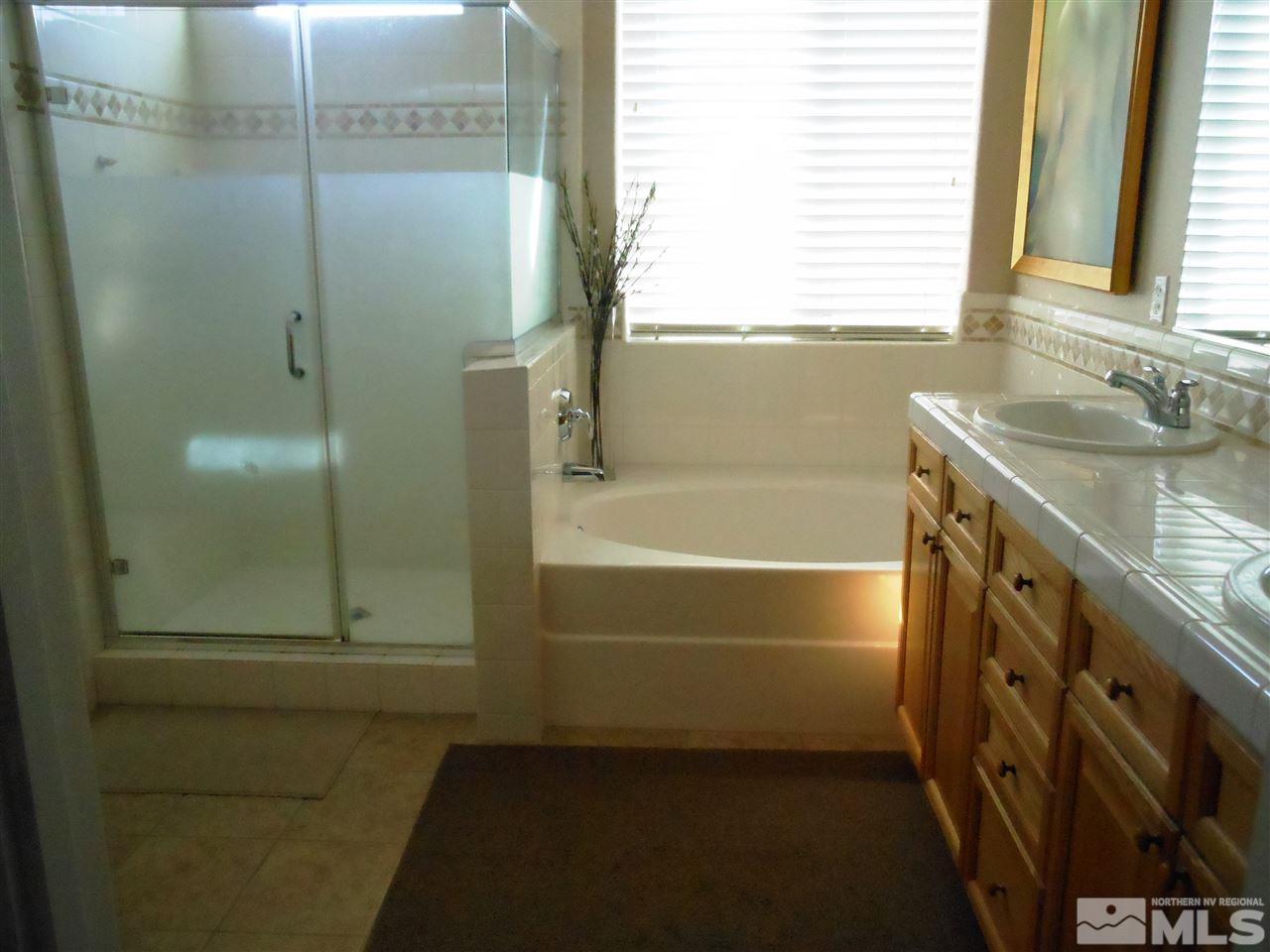 1624 Sewell Drive Reno, NV 89521 - Photo 5 of 14 a bathroom with a granite countertop sink and a mirror