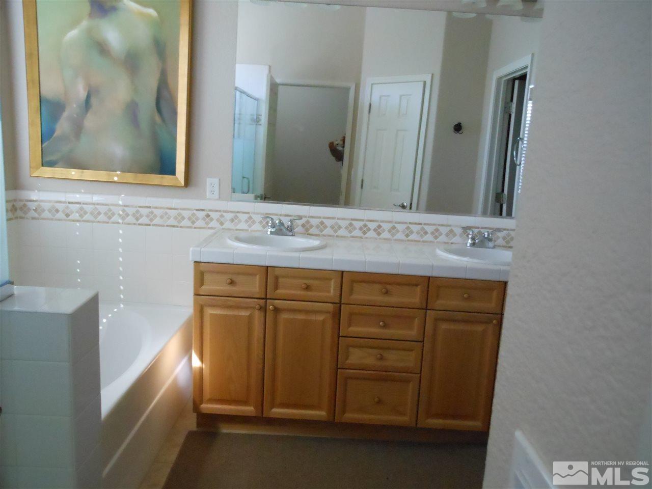 1624 Sewell Drive Reno, NV 89521 - Photo 6 of 14 a bathroom with a sink and a mirror