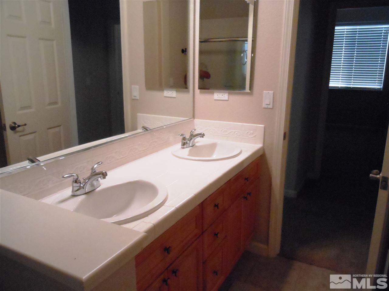 1624 Sewell Drive Reno, NV 89521 - Photo 8 of 14 a bathroom with a sink and a mirror