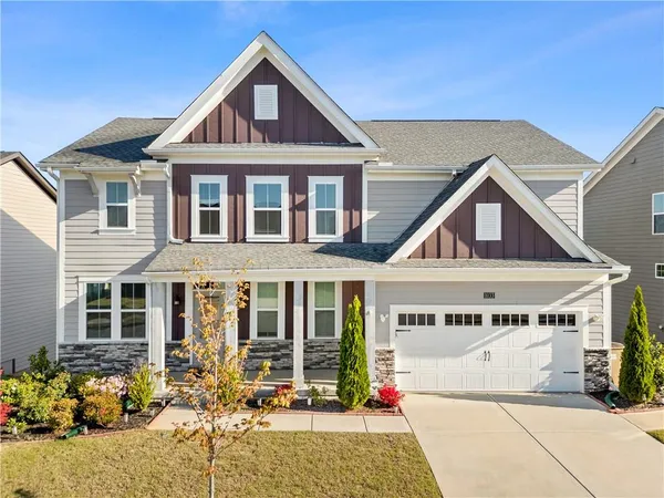 a front view of a house with a yard