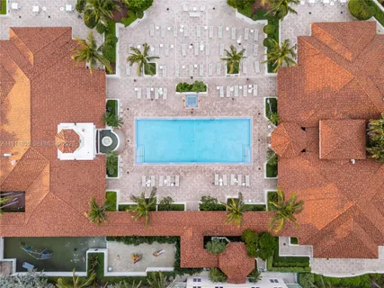 an aerial view of residential houses with outdoor space and parking
