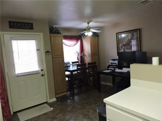 a kitchen with a sink a refrigerator and cabinets