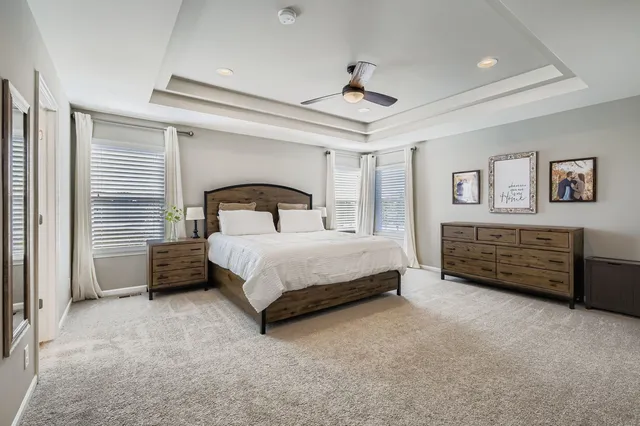 a bedroom with a bed dresser and a window