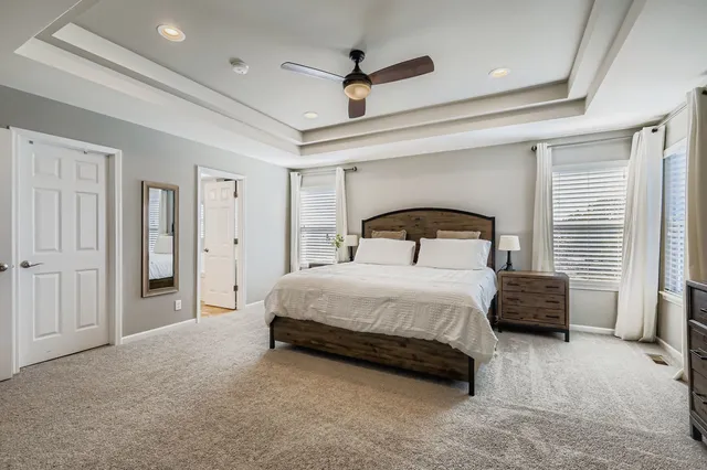 a bedroom with a bed and a ceiling fan