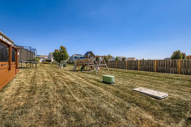 a view of a backyard with lawn chairs
