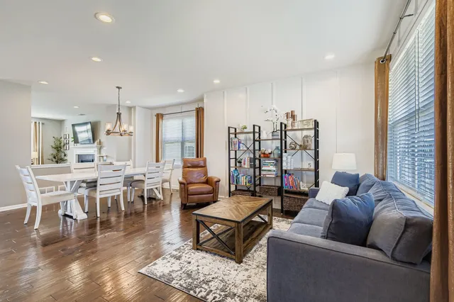a living room with furniture a rug and a large window