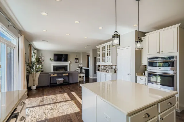 a kitchen with sink a counter top space appliances and cabinets