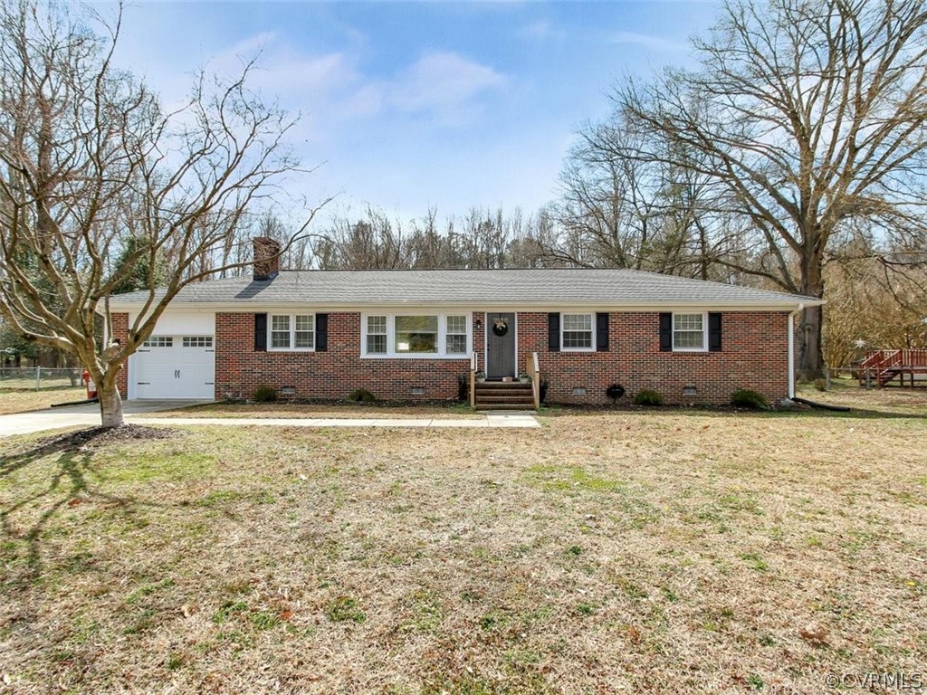 1315 Covington Road Colonial Heights, VA 23834 - Photo 1 of 24 a house with trees in front of it