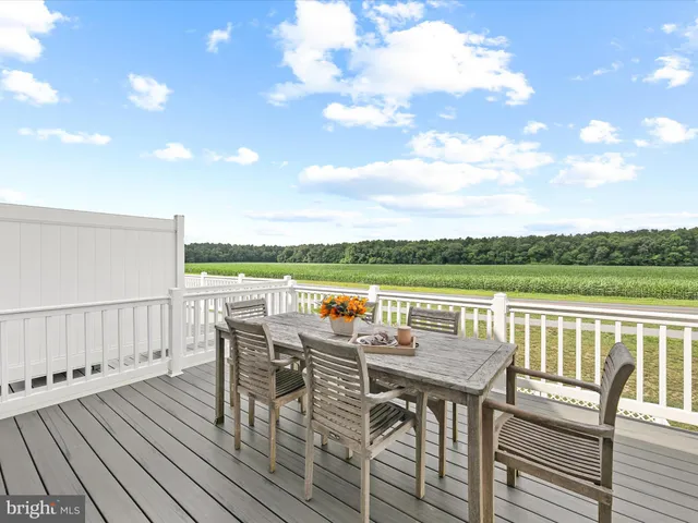 a view of a balcony with table and chairs