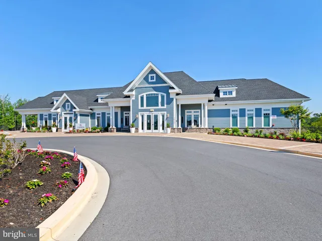 a view of a patio with table and chairs potted plants with wooden floor and fence