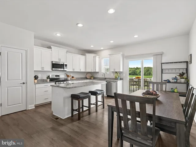 a kitchen with counter space dining table and chairs