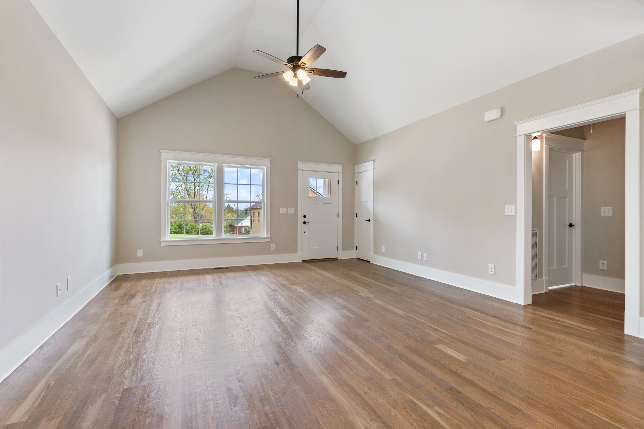 102 Mccreary Dickson, TN 37055 - Photo 4 of 31 an empty room with wooden floor chandelier fan and windows