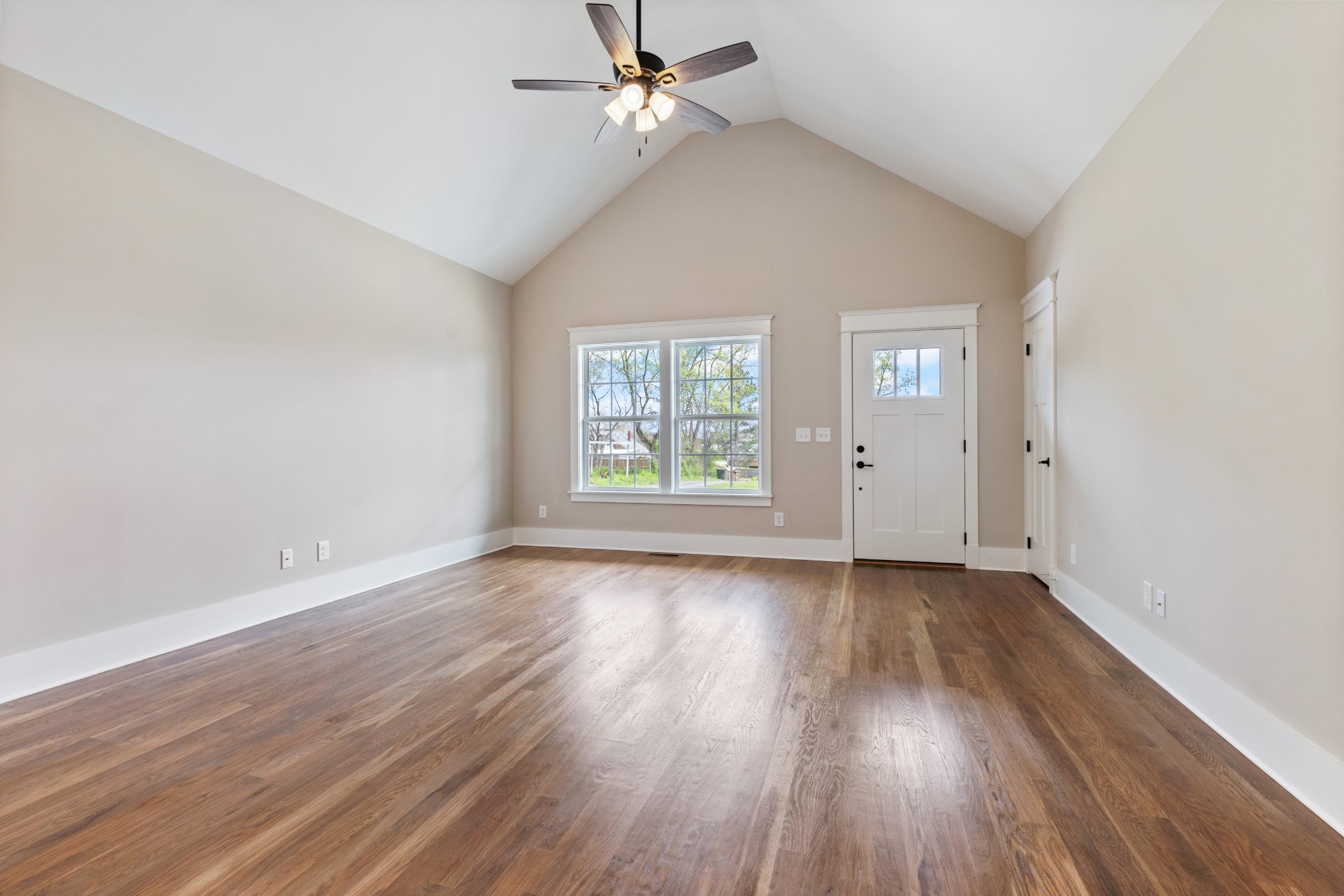 102 Mccreary Dickson, TN 37055 - Photo 5 of 31 an empty room with wooden floor ceiling fan and windows