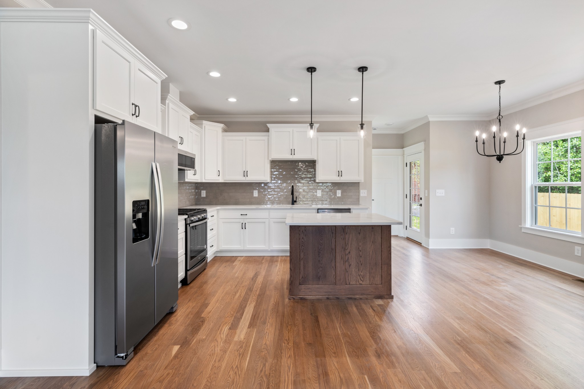 102 Mccreary Dickson, TN 37055 - Photo 8 of 31 a large kitchen with kitchen island a sink stainless steel appliances and cabinets