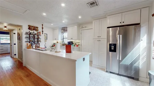 a kitchen with stainless steel appliances a refrigerator and a sink