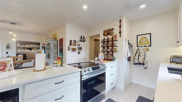a kitchen with a sink stove and refrigerator
