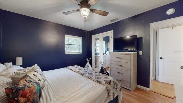a bedroom with a bed and a flat screen tv