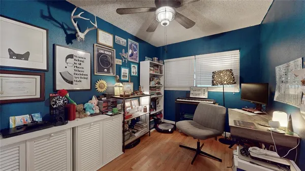 a view of a workspace with furniture and a window