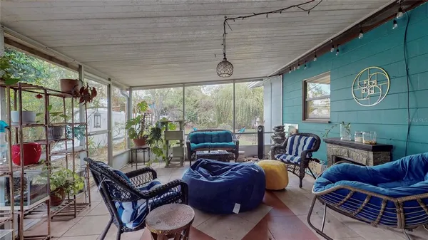 a living room with furniture a ceiling fan and a window