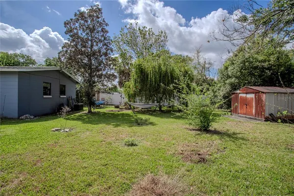 a view of backyard with seating and green space