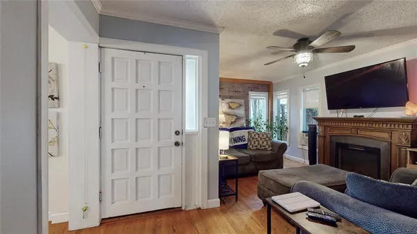 a living room with furniture a flat screen tv and a fireplace