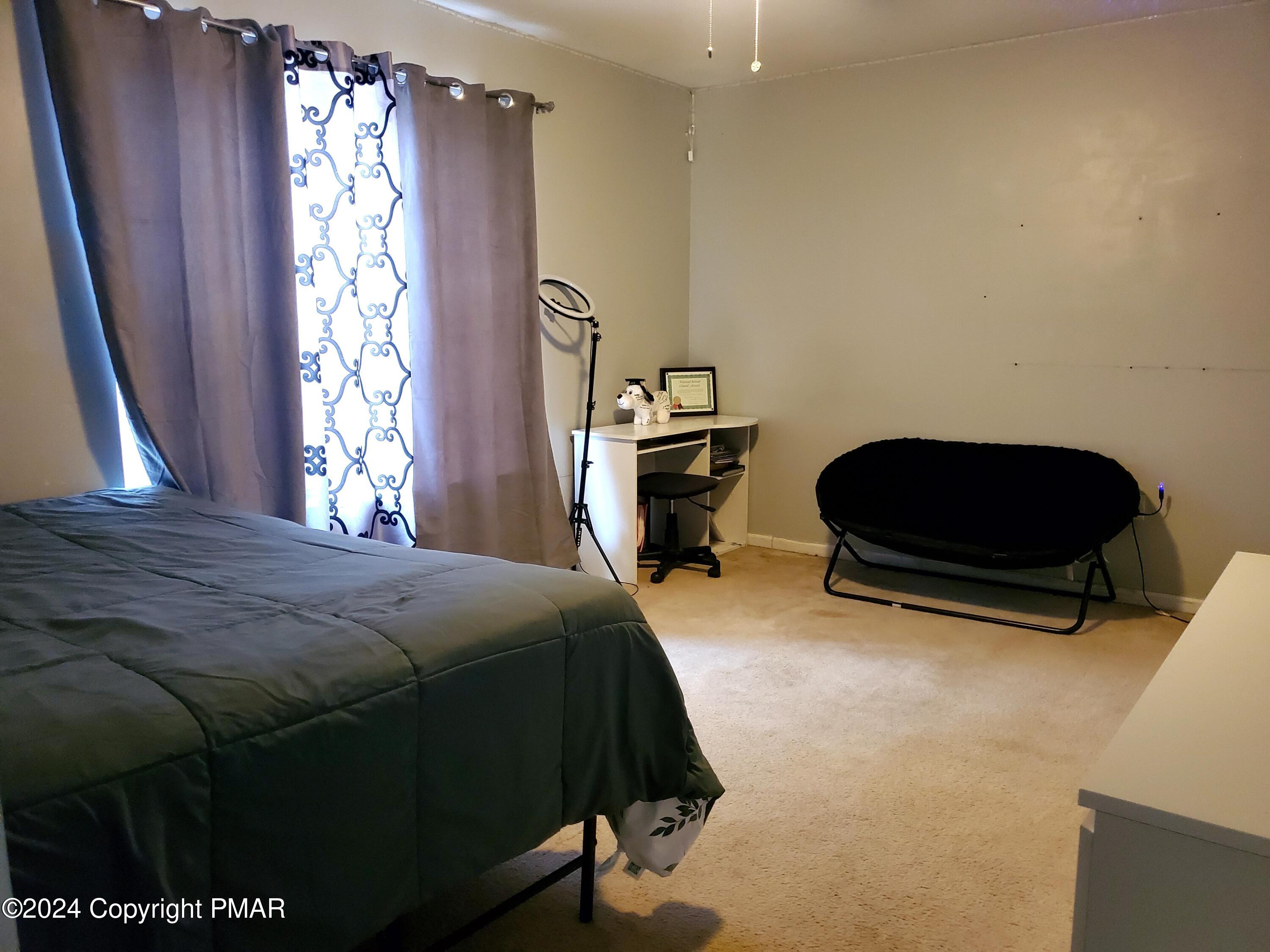 1102 Steele Circle Bushkill, PA 18324 - Photo 11 of 23 a bedroom with a bed and a chair