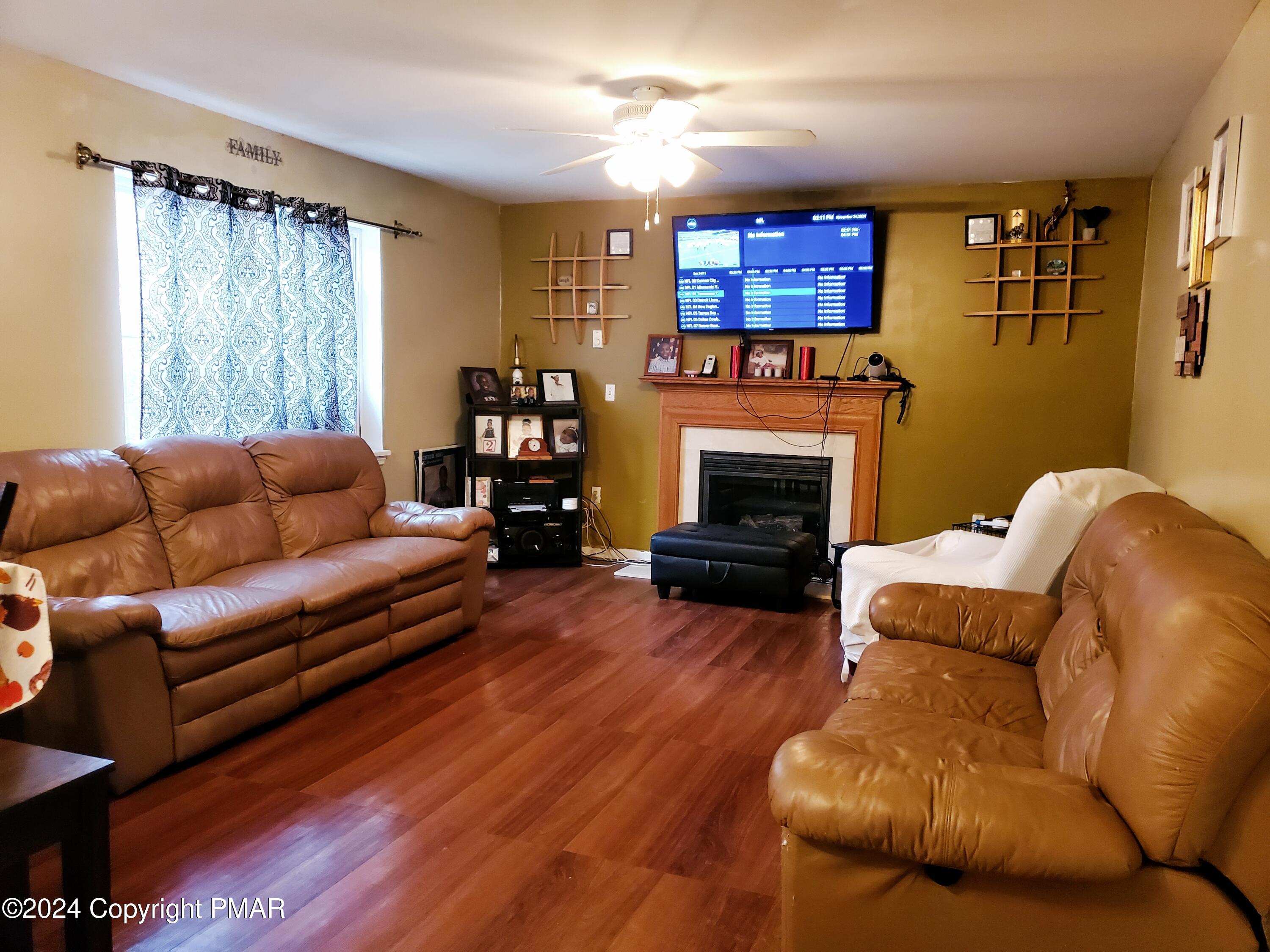 1102 Steele Circle Bushkill, PA 18324 - Photo 15 of 23 a living room with furniture fireplace and a window